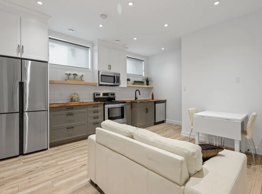 Legal basement suite in Kitsilano, Vancouver — modern kitchen and living area by BRIO Construction