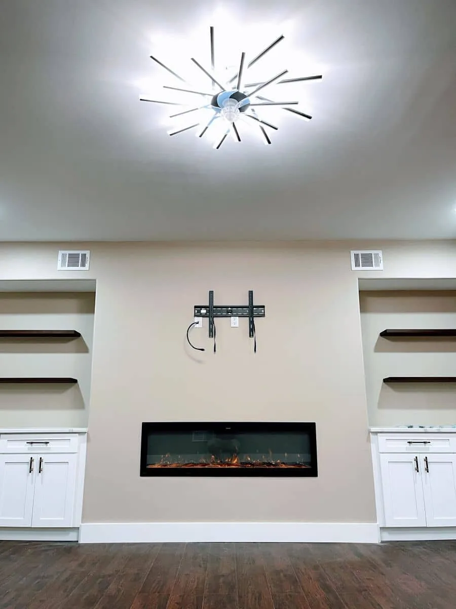 Finished Burnaby basement suite with living room, media wall and built-ins by BRIO Construction