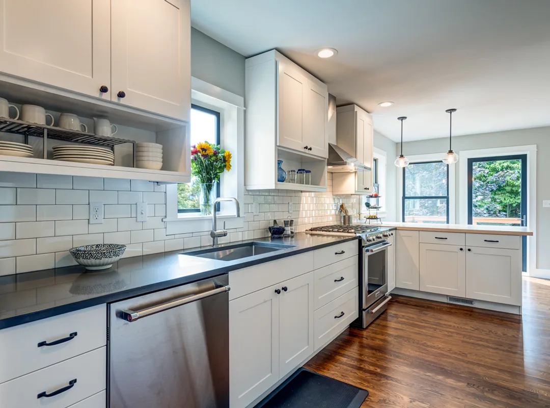 Kitchen renovation in Kitsilano — custom shaker cabinets, quartz waterfall island